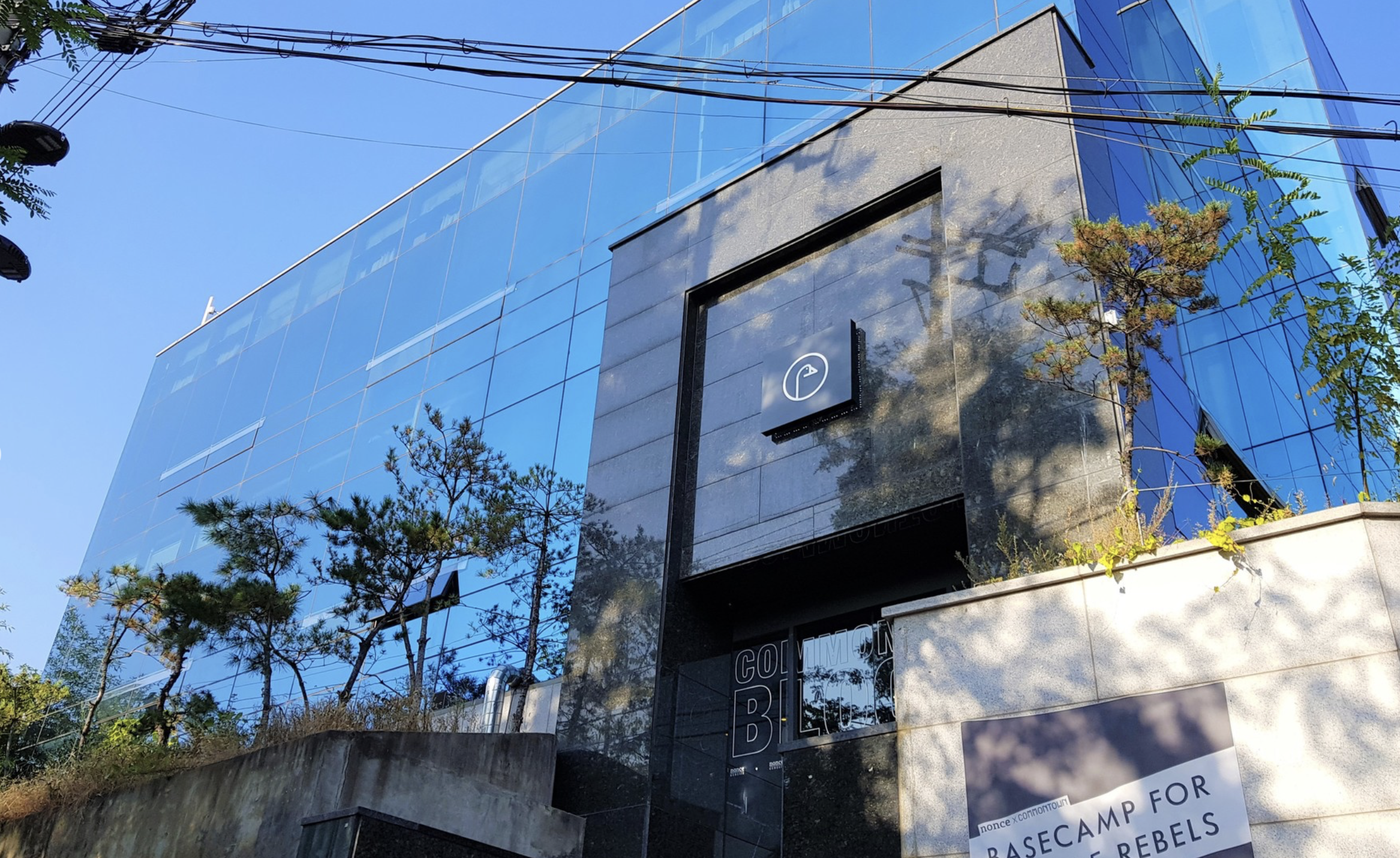 CultX AI Center campus in Gangnam, Seoul at night, with studios glowing with collaborating creators